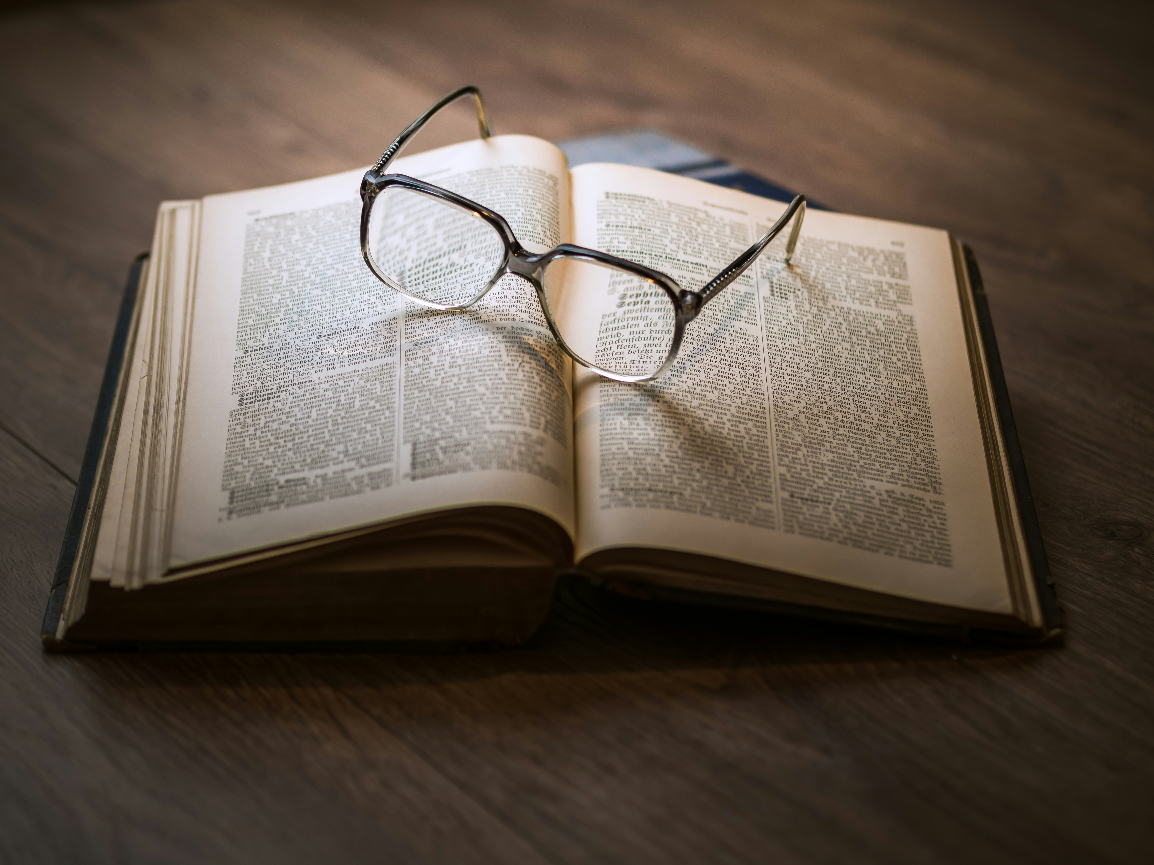 framed eyeglasses on top open book